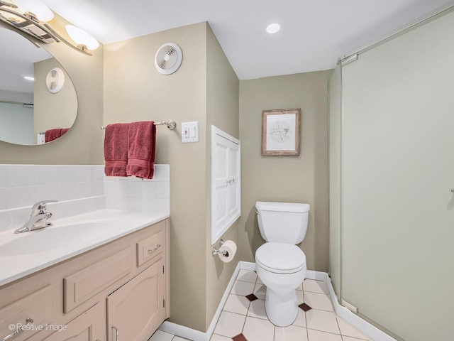 bathroom featuring toilet, tile patterned flooring, vanity, baseboards, and recessed lighting