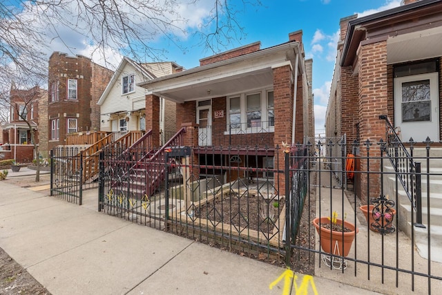 1230 S 57th Ct, Cicero, IL 60804 - view of front facade with brick siding, a fenced front yard, covered porch, and stairs