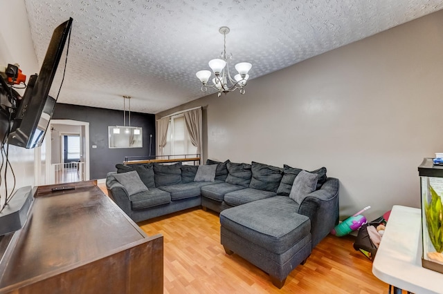 1230 S 57th Ct, Cicero, IL 60804 - living room with a textured ceiling, a chandelier, and light wood-style floors