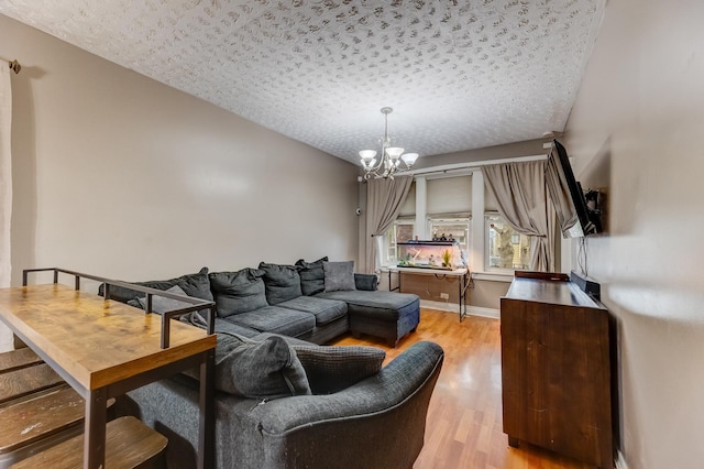 1230 S 57th Ct, Cicero, IL 60804 - living room with light wood-style flooring, a chandelier, a textured ceiling, and baseboards