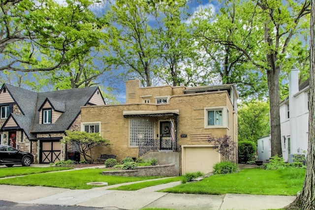 6911 N Wildwood Ave, Chicago, IL 60646 - view of front of home with a garage, brick siding, a front lawn, and driveway