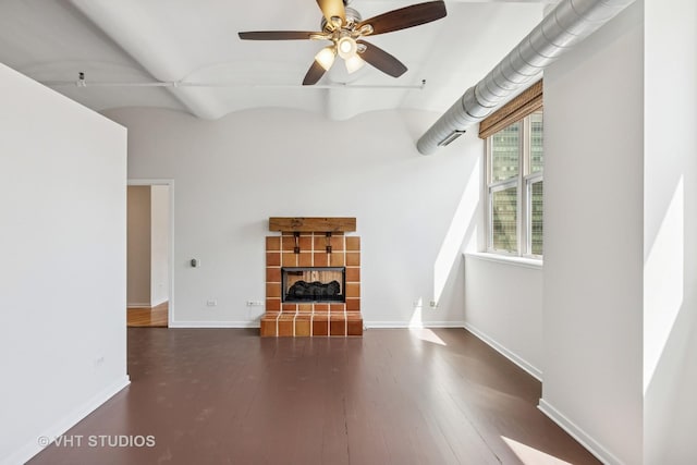 unfurnished living room featuring a fireplace, hardwood / wood-style floors, baseboards, and ceiling fan