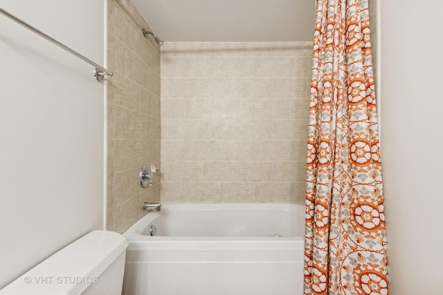 bathroom with shower / bath combo with shower curtain and toilet