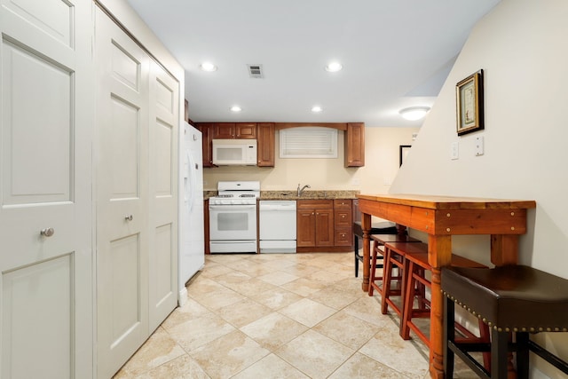 2936 Warbler Pl, Highland Park, IL 60035 - kitchen featuring white appliances, brown cabinets, light countertops, recessed lighting, and a sink