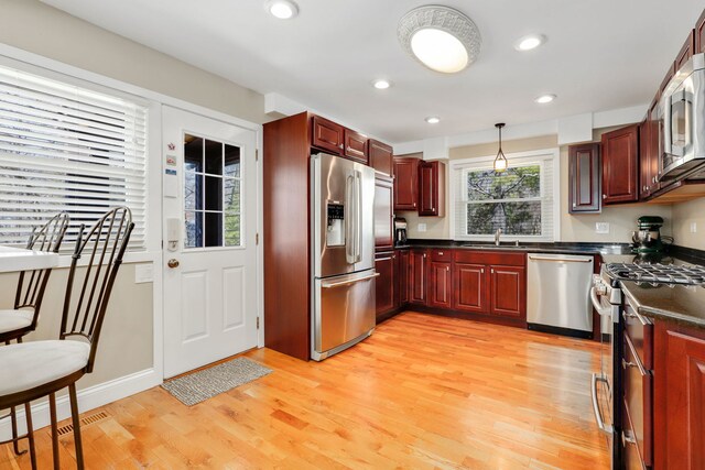2936 Warbler Pl, Highland Park, IL 60035 - kitchen featuring appliances with stainless steel finishes, a sink, light wood-type flooring, pendant lighting, and recessed lighting
