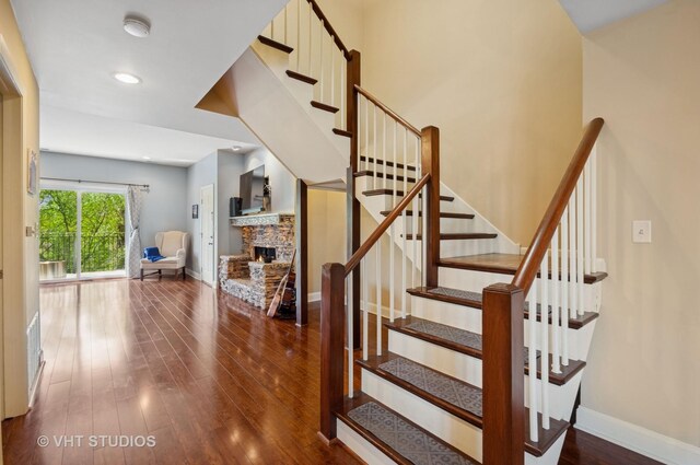 670 Ballantrae Dr Unit 900C, Northbrook, IL 60062 - staircase featuring wood-type flooring, a stone fireplace, baseboards, and recessed lighting