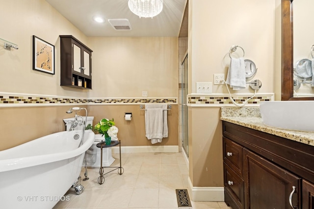 670 Ballantrae Dr Unit 900C, Northbrook, IL 60062 - bathroom featuring a stall shower, vanity, a freestanding bath, tile patterned floors, and a chandelier