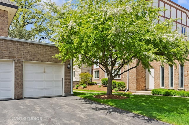 670 Ballantrae Dr Unit 900C, Northbrook, IL 60062 - view of front facade with an attached garage, brick siding, and driveway