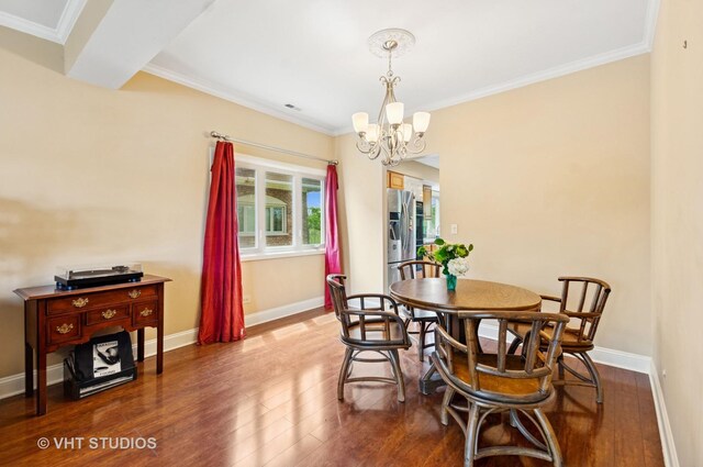 670 Ballantrae Dr Unit 900C, Northbrook, IL 60062 - dining room featuring crown molding, a chandelier, wood finished floors, and baseboards