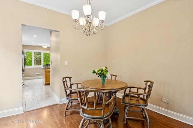 670 Ballantrae Dr Unit 900C, Northbrook, IL 60062 - dining room with a chandelier, baseboards, wood finished floors, and crown molding