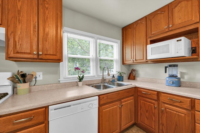 505 S Maple St, Urbana, IL 61801 - kitchen with white appliances, a sink, brown cabinets, and light countertops