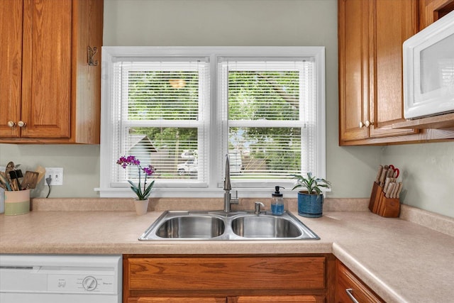 505 S Maple St, Urbana, IL 61801 - kitchen with white appliances, a sink, light countertops, and brown cabinetry