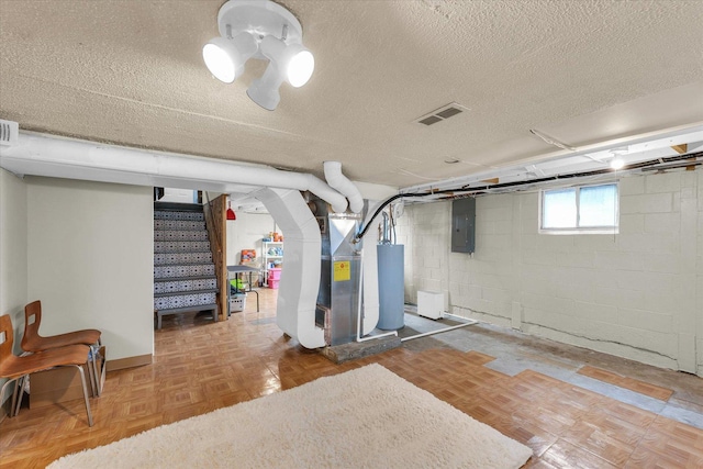 505 S Maple St, Urbana, IL 61801 - below grade area featuring electric panel, stairs, water heater, a textured ceiling, and concrete block wall