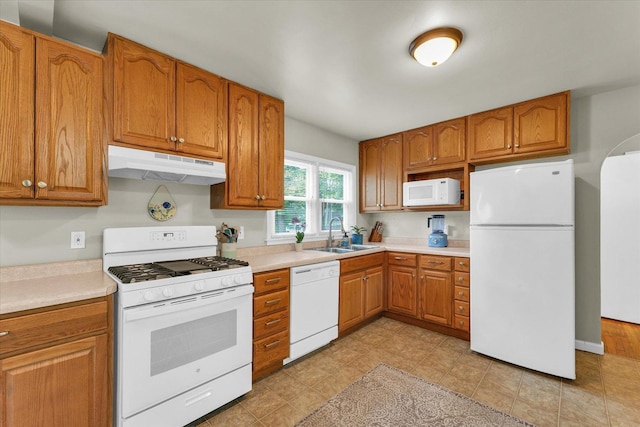 505 S Maple St, Urbana, IL 61801 - kitchen featuring white appliances, under cabinet range hood, a sink, and brown cabinetry