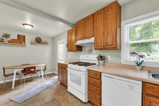 505 S Maple St, Urbana, IL 61801 - kitchen featuring white appliances, under cabinet range hood, light countertops, brown cabinetry, and a sink