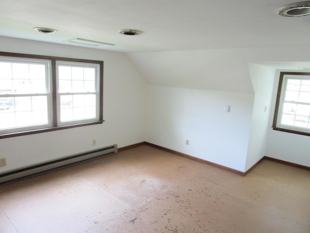 bonus room featuring baseboard heating, lofted ceiling, and baseboards