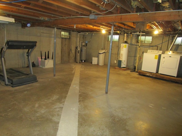 unfinished basement featuring water heater, washer and clothes dryer, and gas water heater