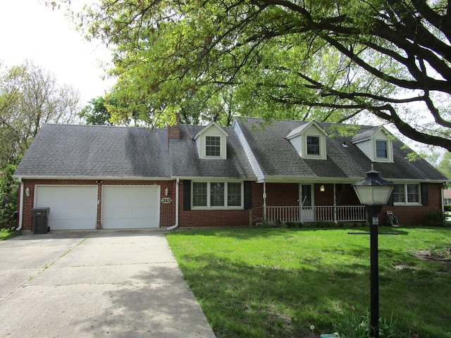 cape cod home featuring an attached garage, a front yard, and brick siding