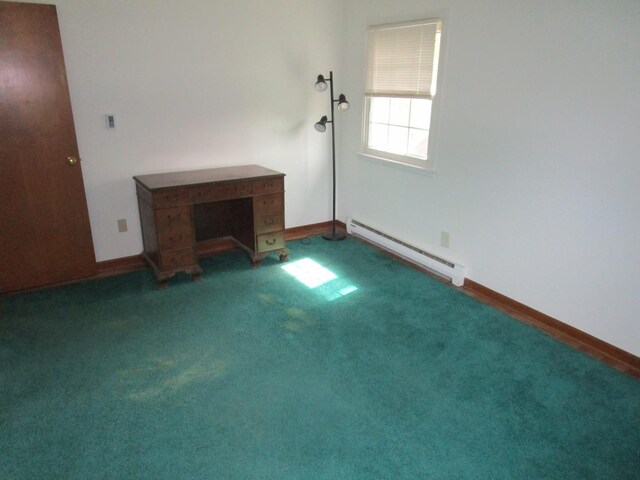 carpeted spare room featuring a baseboard heating unit and baseboards