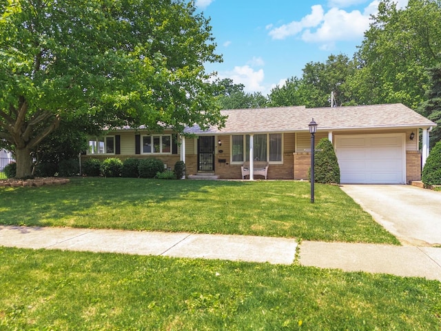504 Delmar Ln, Bloomington, IL 61701 - ranch-style home with a garage, driveway, a front lawn, and brick siding