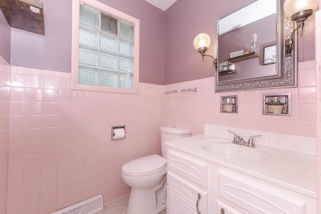 504 Delmar Ln, Bloomington, IL 61701 - bathroom with tile walls, vanity, and a wainscoted wall