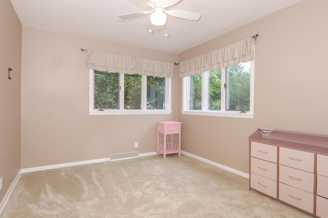 504 Delmar Ln, Bloomington, IL 61701 - unfurnished bedroom featuring light carpet and a ceiling fan