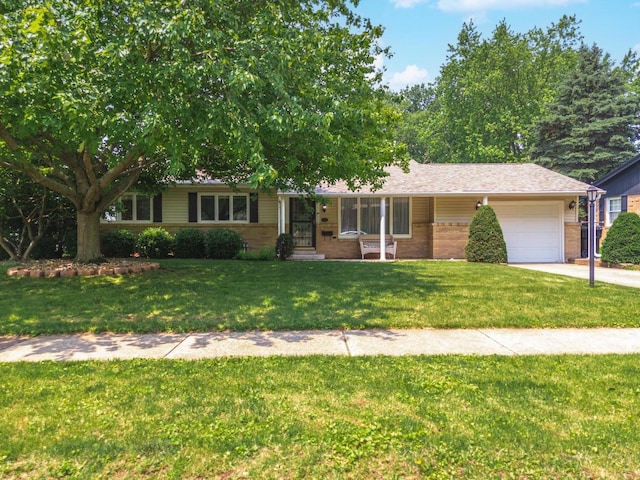 504 Delmar Ln, Bloomington, IL 61701 - single story home featuring an attached garage, a front lawn, brick siding, and driveway