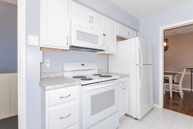 504 Delmar Ln, Bloomington, IL 61701 - kitchen with white appliances, light countertops, white cabinetry, and light tile patterned flooring