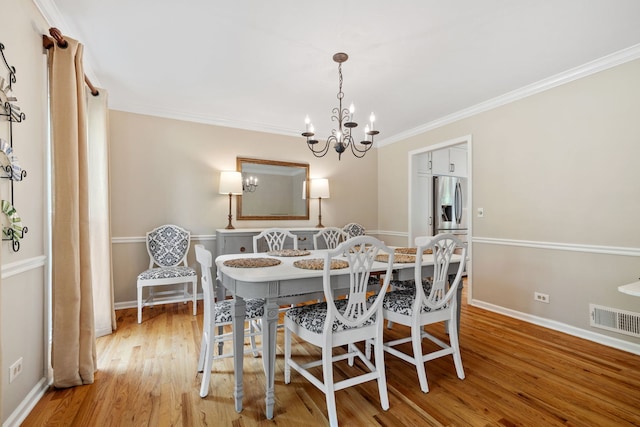 424 Dilorenzo Dr, Naperville, IL 60565 - dining room featuring a chandelier, wood finished floors, crown molding, and baseboards