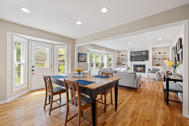 424 Dilorenzo Dr, Naperville, IL 60565 - dining room featuring a fireplace, light wood-style flooring, recessed lighting, baseboards, and built in features