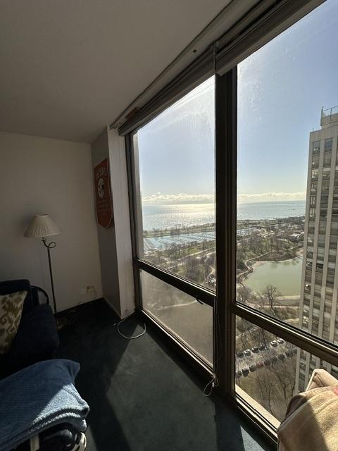 living room featuring a water view and carpet flooring