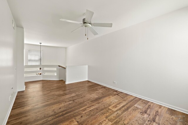 unfurnished room with wood finished floors, ceiling fan, and baseboards