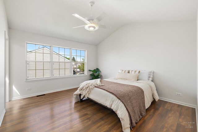 bedroom with lofted ceiling, wood finished floors, baseboards, and a ceiling fan