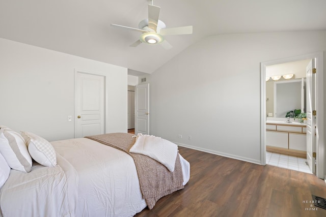 bedroom with lofted ceiling, wood finished floors, connected bathroom, ceiling fan, and baseboards