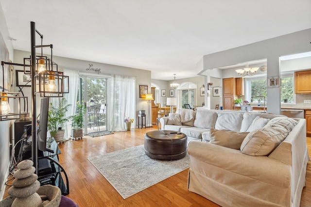 5155 Madison St Unit 204, Skokie, IL 60077 - living room featuring a chandelier and light wood-type flooring