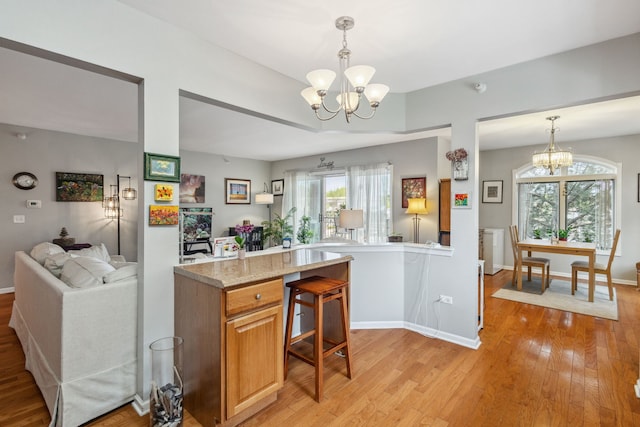 5155 Madison St Unit 204, Skokie, IL 60077 - kitchen with a chandelier, open floor plan, light wood-style flooring, and decorative light fixtures