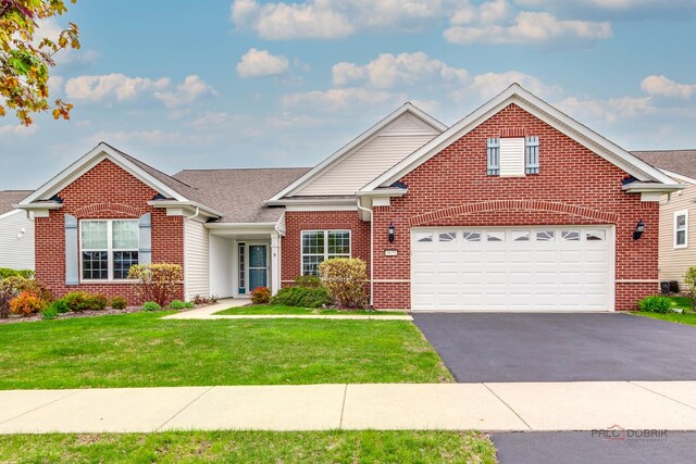 3629 Canton Cir, Mundelein, IL 60060 - traditional-style home featuring brick siding, asphalt driveway, a front yard, and an attached garage