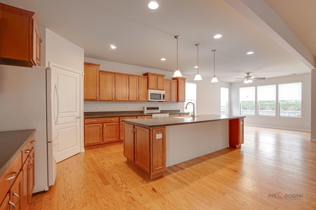 3629 Canton Cir, Mundelein, IL 60060 - kitchen with white appliances, a sink, dark countertops, ceiling fan, and light wood finished floors