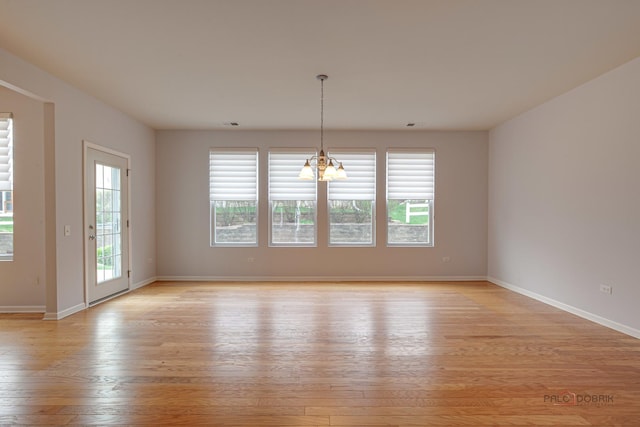 3629 Canton Cir, Mundelein, IL 60060 - unfurnished room featuring light wood-style floors, a chandelier, and baseboards