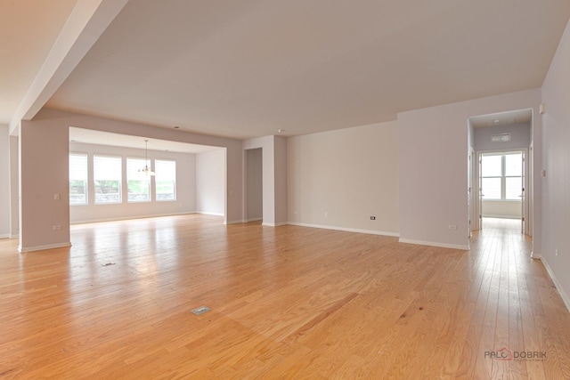 3629 Canton Cir, Mundelein, IL 60060 - empty room with healthy amount of natural light, light wood-style floors, a chandelier, and baseboards