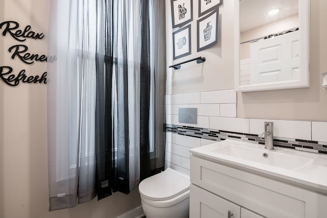 9841 S Ewing Ave, Chicago, IL 60617 - half bath featuring tile walls, toilet, and vanity