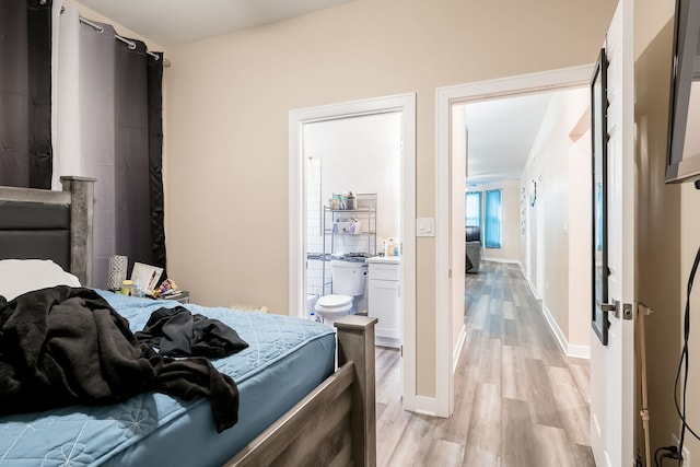 9841 S Ewing Ave, Chicago, IL 60617 - bedroom featuring light wood-style flooring, connected bathroom, and baseboards