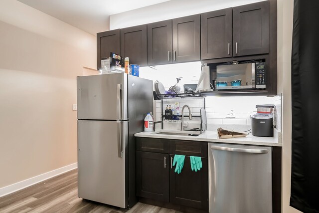 9841 S Ewing Ave, Chicago, IL 60617 - kitchen featuring appliances with stainless steel finishes, a sink, light wood finished floors, and light countertops