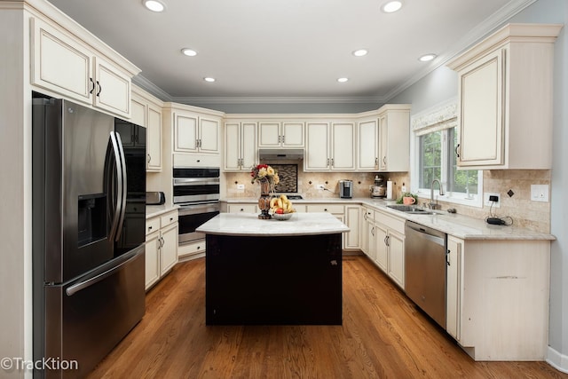 504 Lindley Ave, Westmont, IL 60559 - kitchen featuring appliances with stainless steel finishes, a sink, crown molding, under cabinet range hood, and a kitchen island