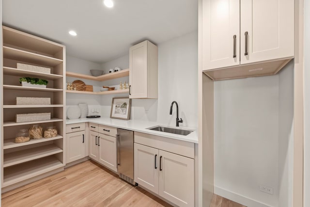 kitchen featuring open shelves, a sink, light wood-style flooring, light countertops, and recessed lighting