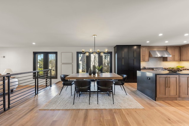 dining space featuring light wood finished floors and recessed lighting