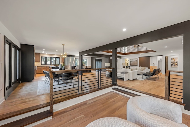 living room featuring light wood-style flooring, a chandelier, and recessed lighting