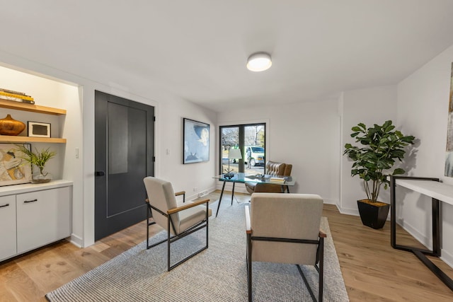office area with light wood-type flooring and baseboards