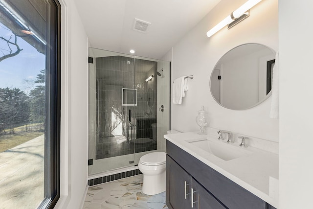 bathroom with marble finish floors, toilet, a stall shower, vanity, and recessed lighting