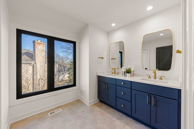 full bathroom with recessed lighting, double vanity, tile patterned flooring, and baseboards